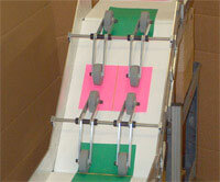 Custom incline decline Lite Series small conveyor moves recycled paper uphill with rollers